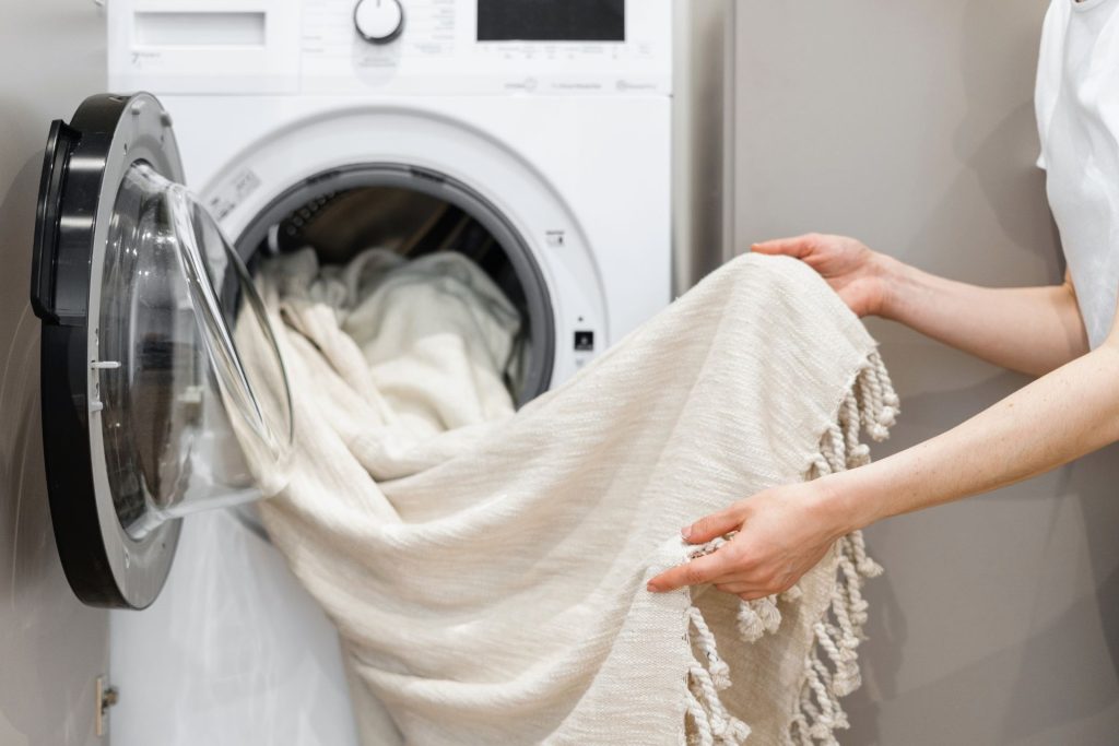 Person using washing machine to wash some clothes