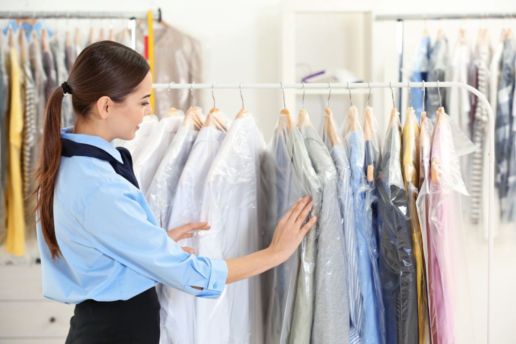 Lady looking through several displayed suits